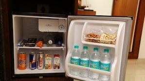 An open refrigerator with beverages and snacks. - The Altruist Andheri Hotel (Mumbai)