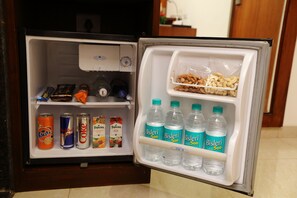 An open refrigerator with beverages and snacks. - The Altruist Andheri Hotel (Mumbai)
