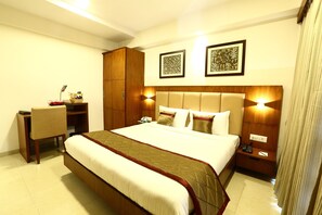 A hotel room with a large bed, a desk, a wardrobe, and two wall-mounted lamps. - The Altruist Andheri Hotel (Mumbai)