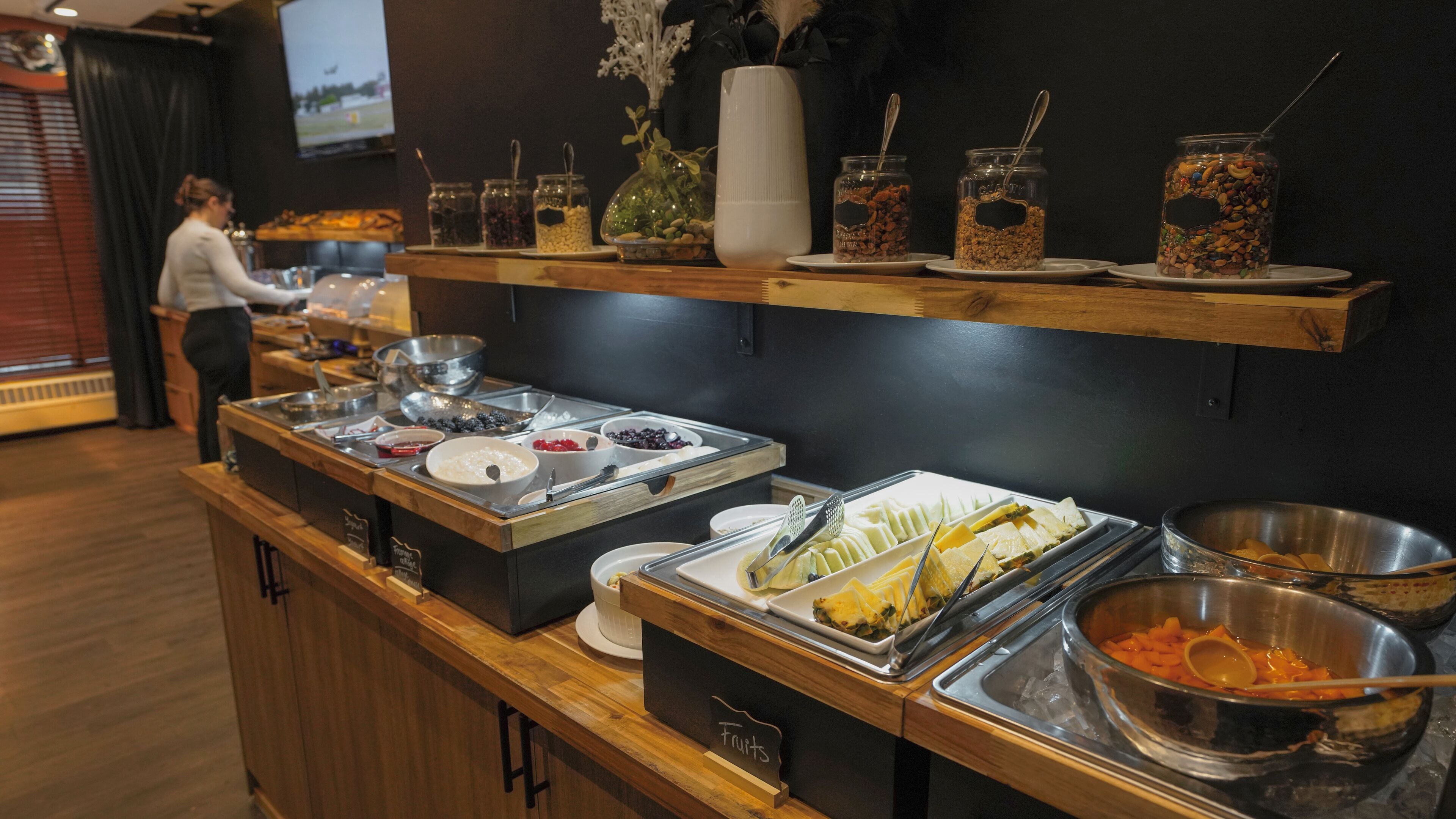 A buffet with various food items and utensils.
