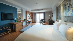 A modern hotel room with a large bed, a desk with a chair, a television, and a large window. - Bespoke Trendy Hotel Hanoi (Hanoi)
