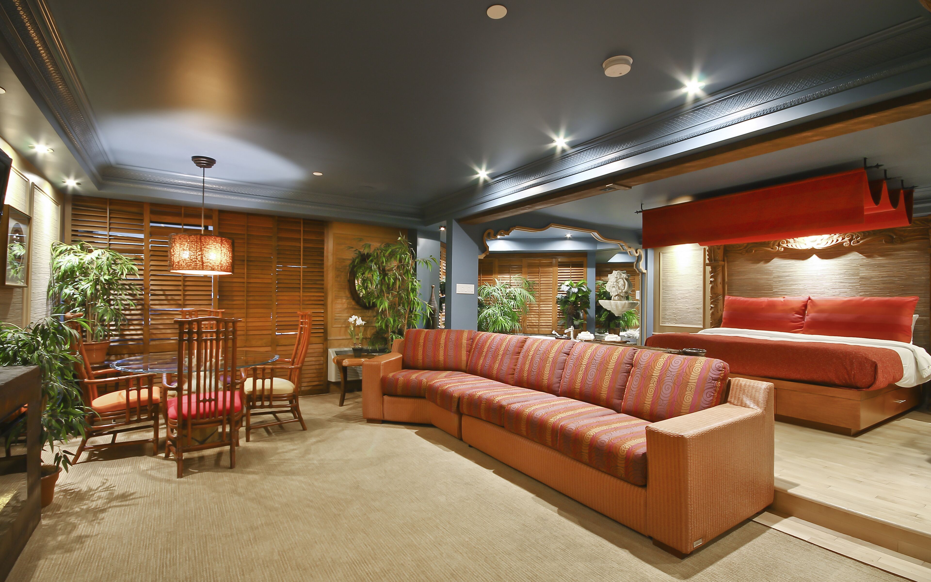 king bed suite with sofa bed - polynesian theme | living area | 32-inch flat-screen tv with cable channels, tv, ipod dock