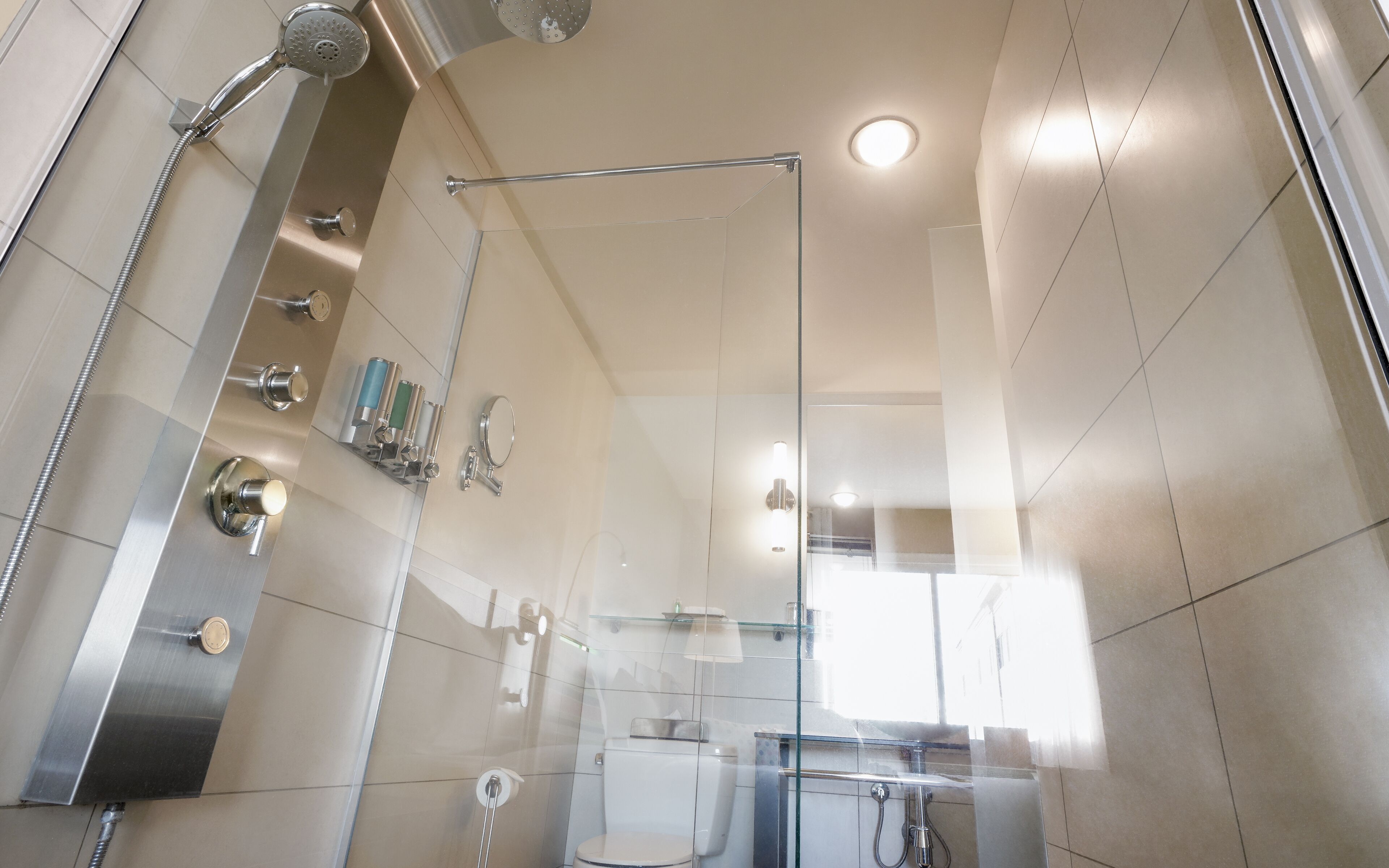 intimacy room, 1 queen bed, fireplace and multi-jet shower | bathroom shower