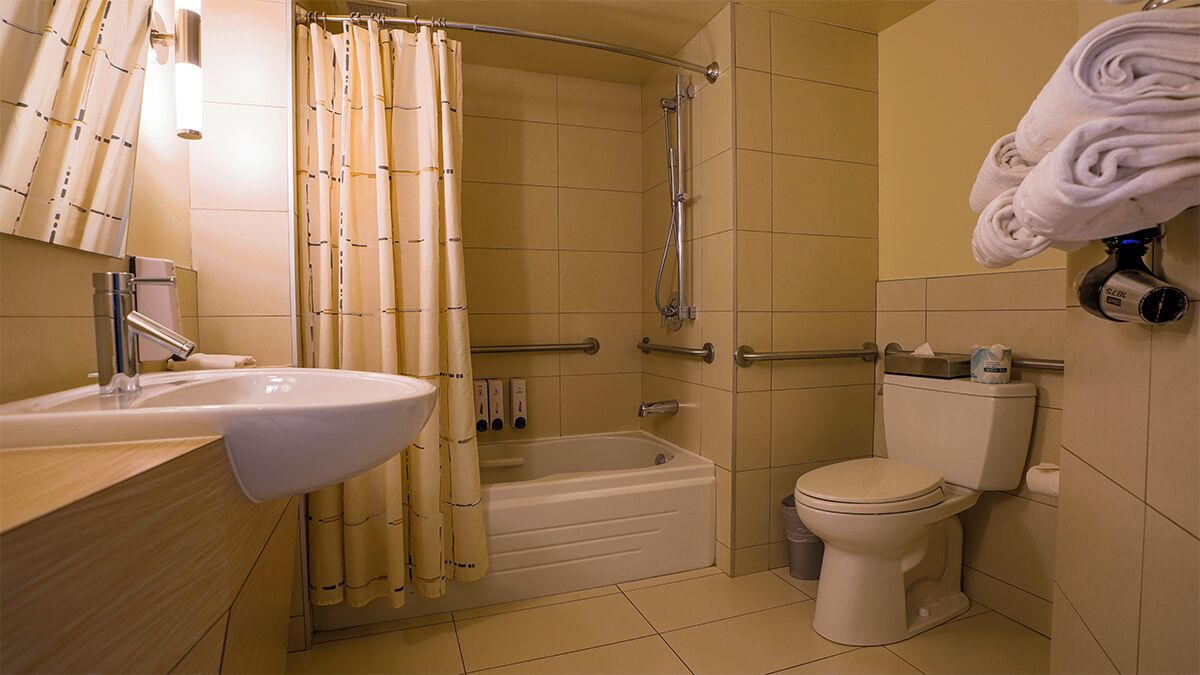 A bathroom with a sink, bathtub, toilet, and shower.