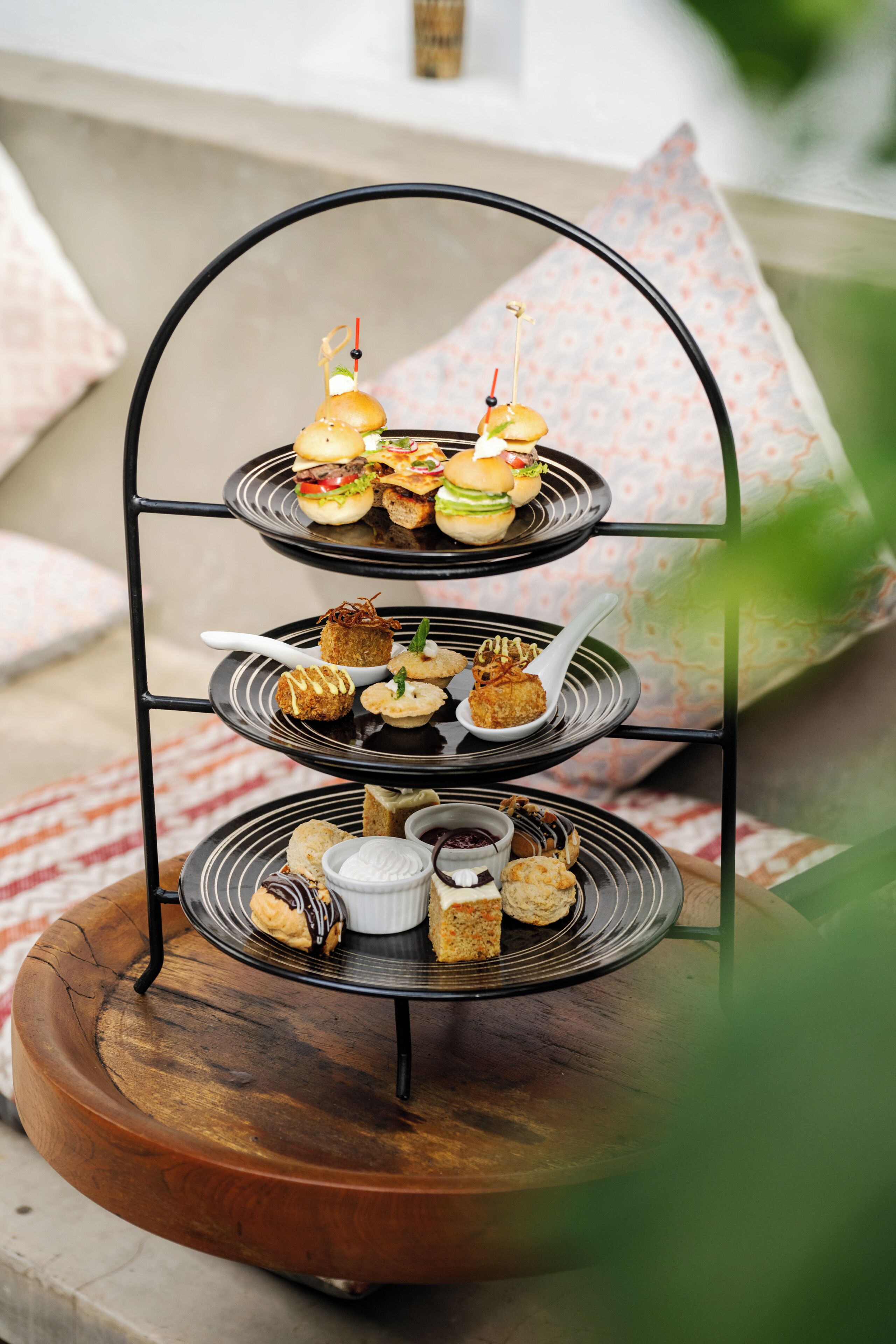 A tiered serving tray with various food items.