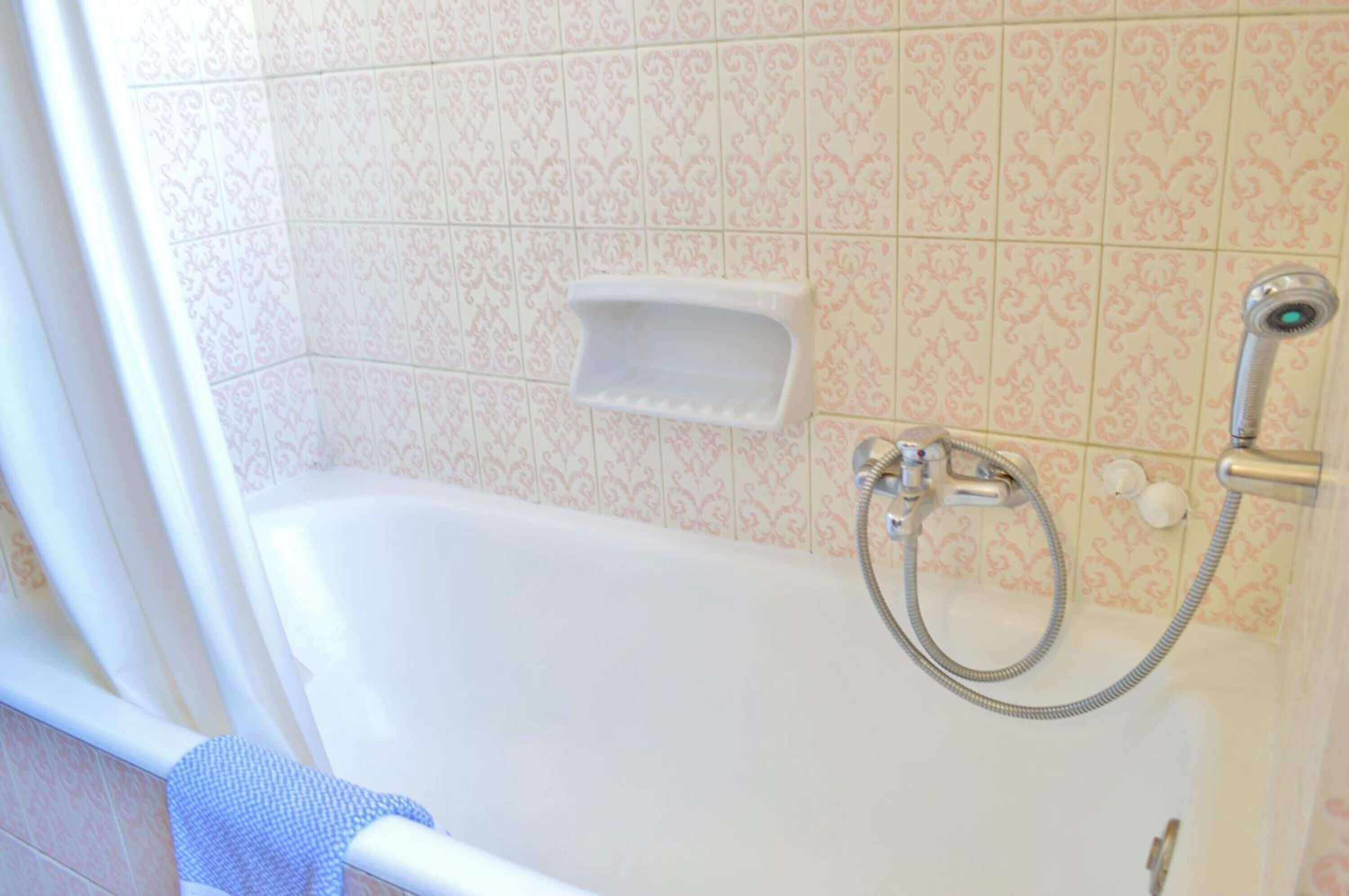 bathtub, designer toiletries, hair dryer, towels