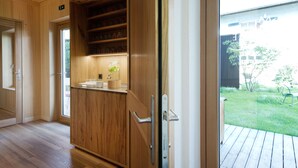 A wooden interior with a glass door leading to a deck. -  Krone Hittisau - Hotel & Restaurant im Bregenzerwald (Hittisau)