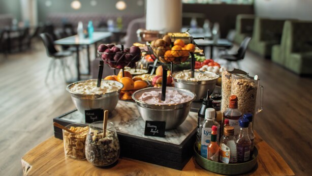 A buffet setup with various food items and condiments. - Hótel Múli (Reykjavik)