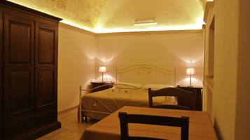 A bedroom with a bed, bedside tables, a chair, and a wardrobe.