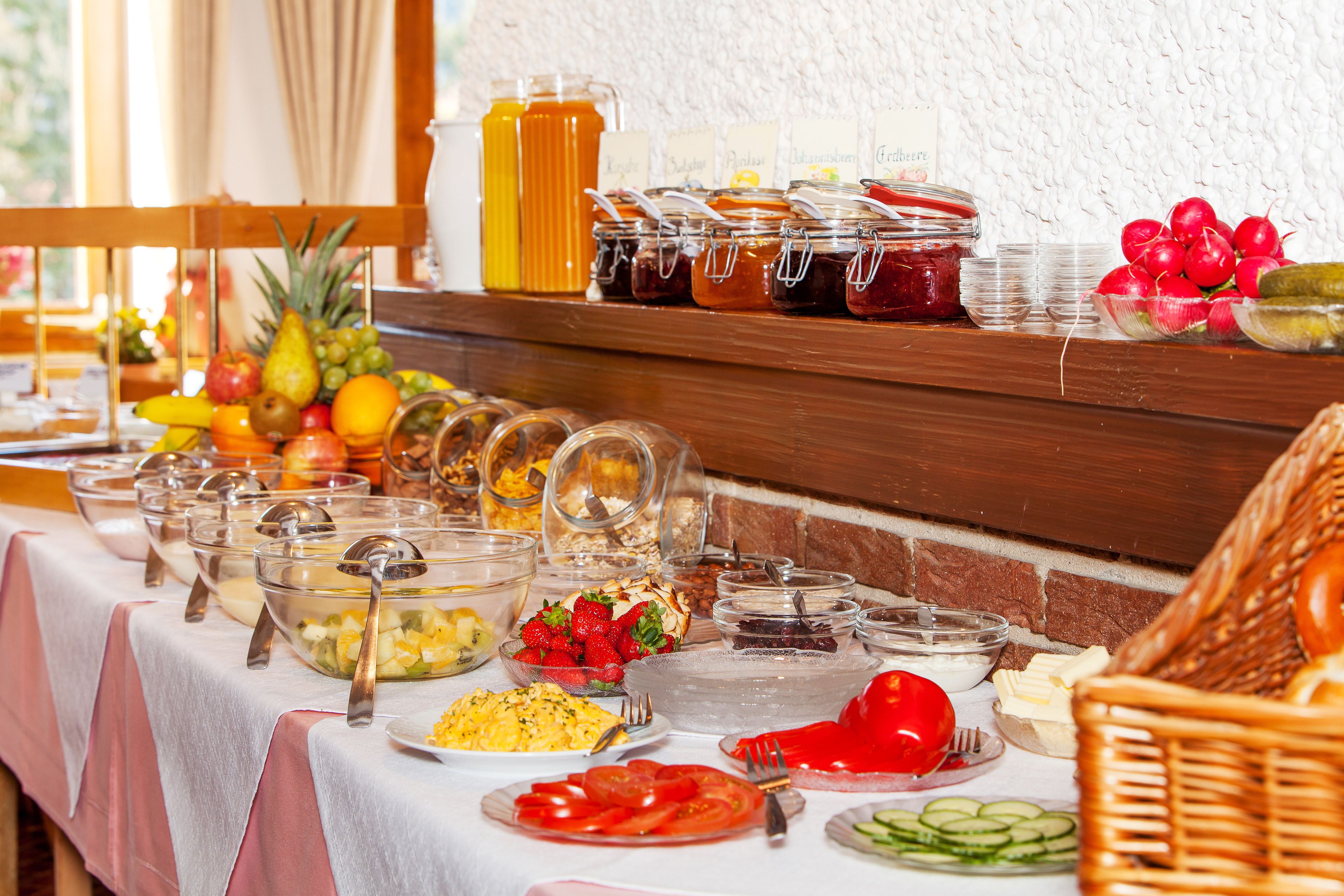 A buffet table with various food items and condiments.