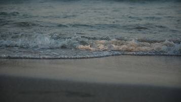 A beach with waves gently crashing onto the shore.