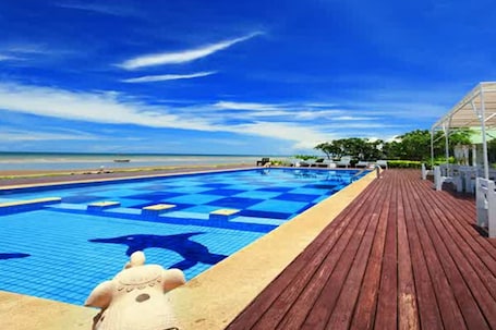 Outdoor pool, pool umbrellas, sun loungers. Sea Sky Beach Resort