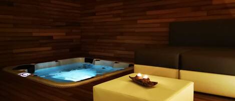 A wooden cabin with a hot tub and a yellow ottoman.