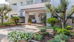 A modern hotel with a spacious outdoor area, including a seating area and a well-maintained garden with various plants and flowers. - A10 Solecito Apartamentos (Alcúdia)