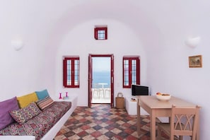 Junior Studio Suite, Hot Tub, Sea View | Living area | 32-inch TV with satellite channels - The Architect's Cave House (Santorini)
