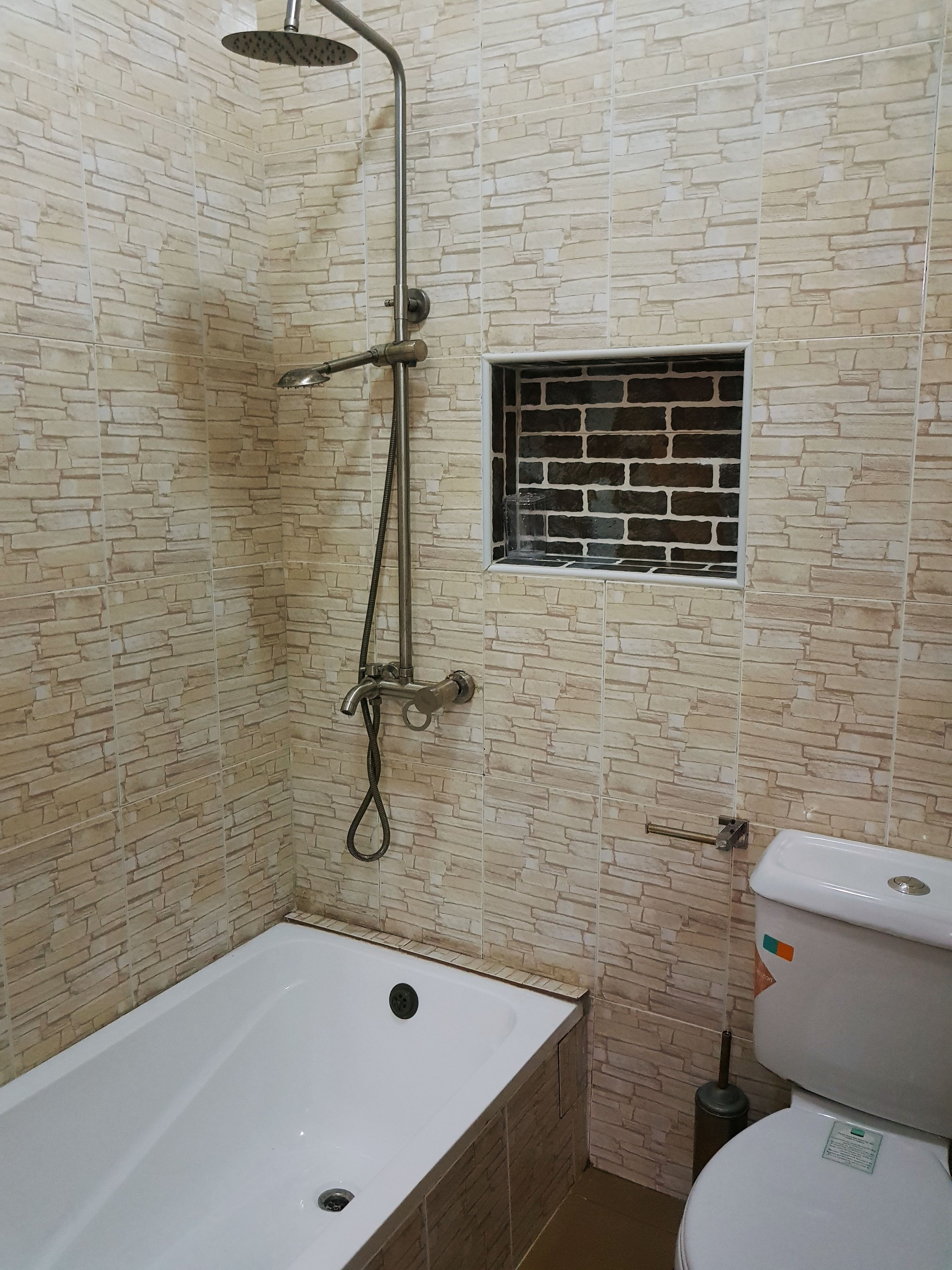 A bathroom with a bathtub, a shower, and a toilet.