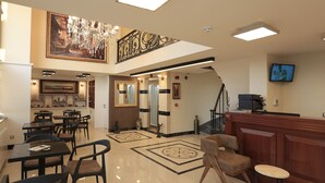 A hotel lobby with a dining area, a reception desk, a staircase, and a chandelier. - Art Nouveau Pera (Istanbul)