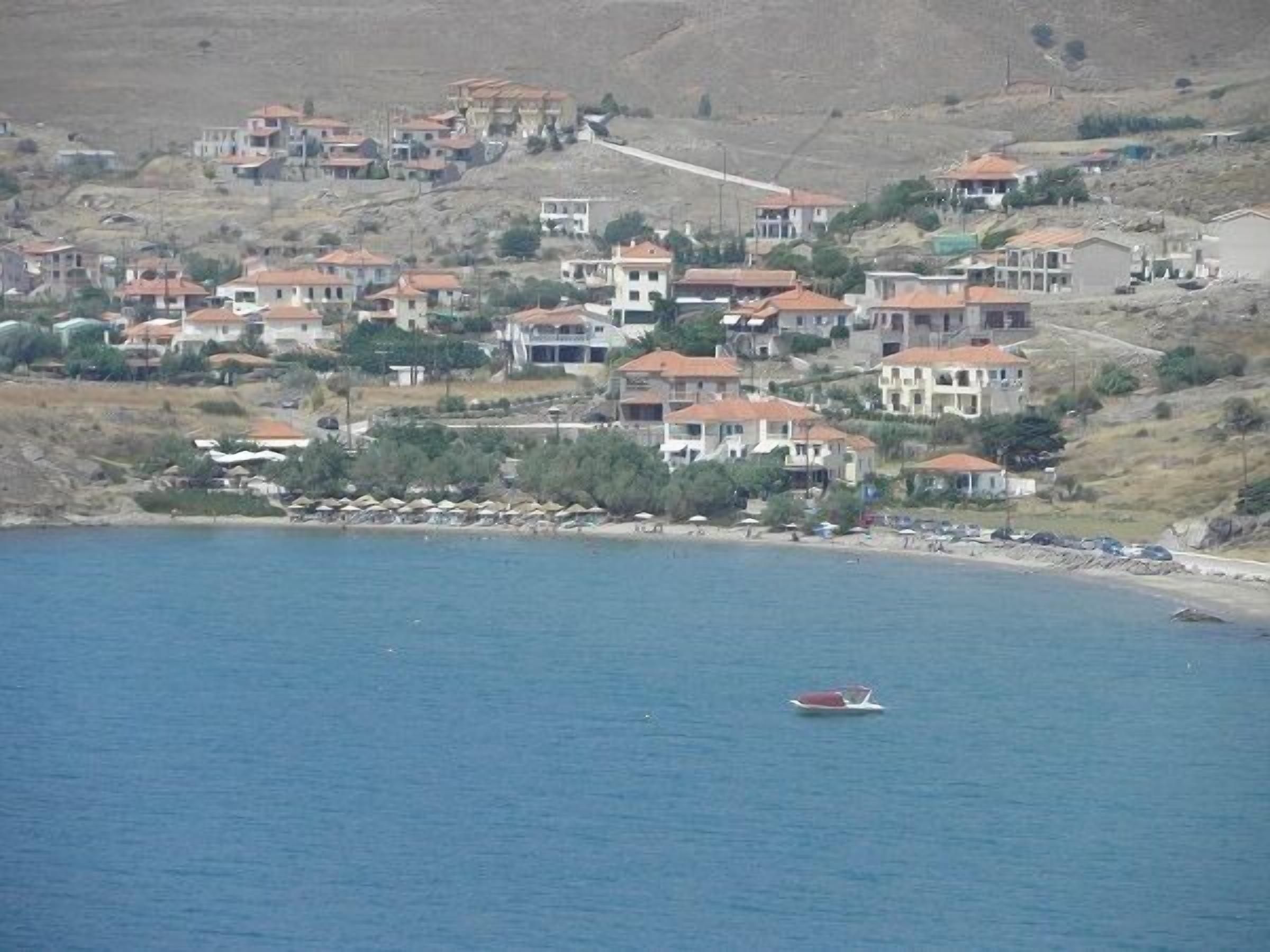 A coastal town with houses on a hillside overlooking the sea.