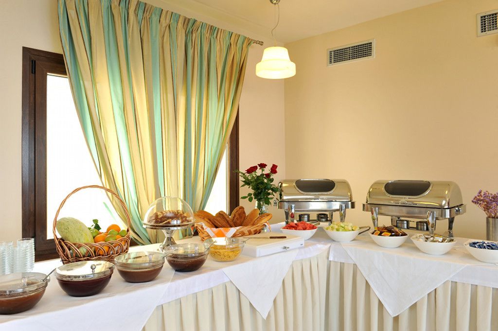 A buffet setup with various food items and a grill station.