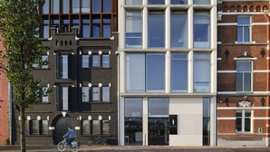 A modern building with large windows and a brick facade.