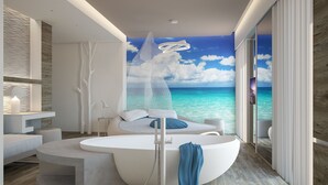 A modern bathroom with a large bathtub, a shower, and a view of the ocean through a large window. - Hotel Liberty Beach (Riccione)