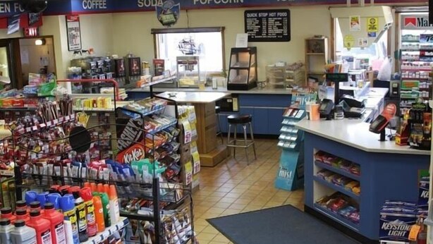 A convenience store with shelves stocked with snacks, beverages, and household items. - Quik Stop and Motel (Wausaukee)