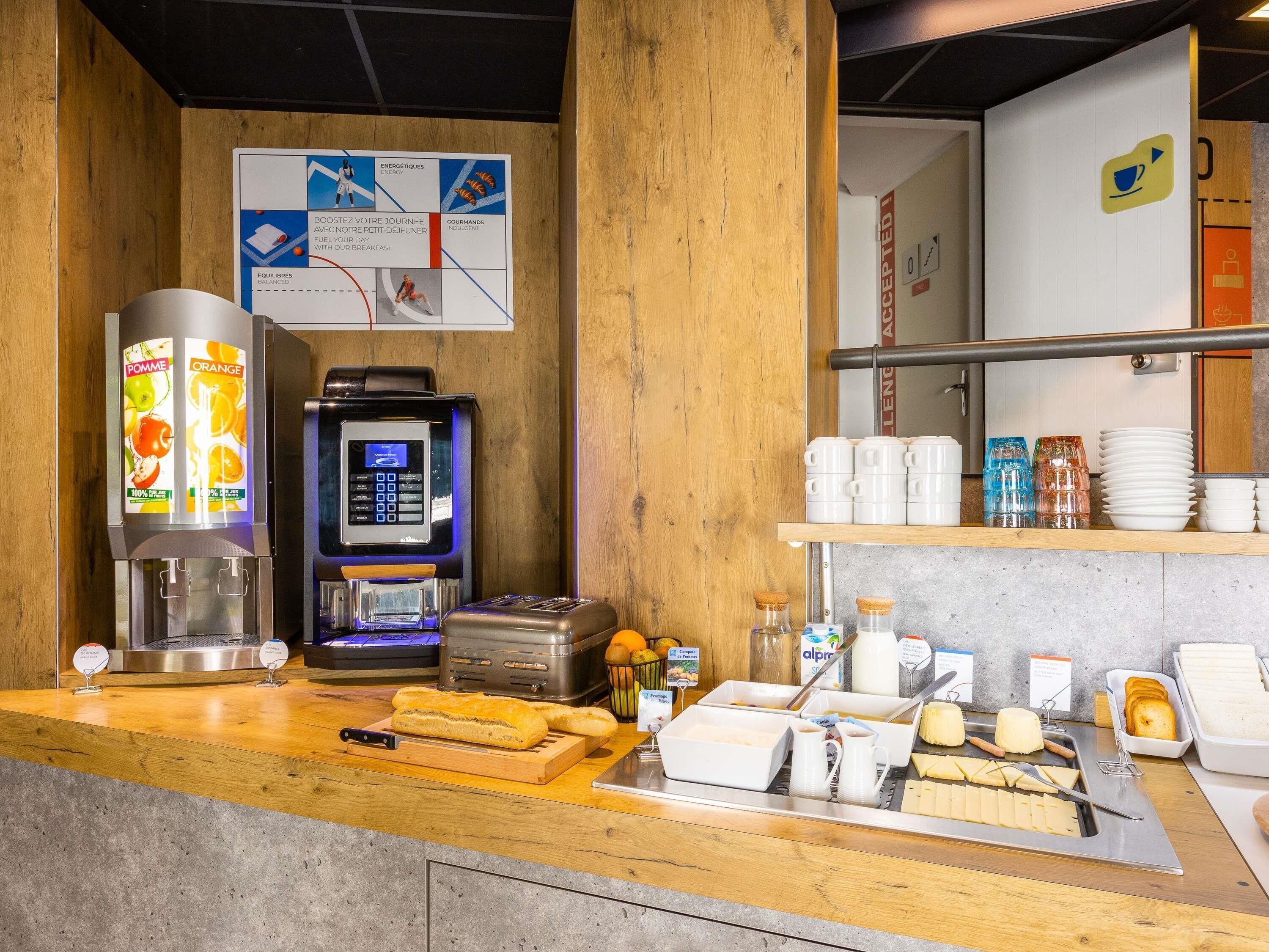 A breakfast bar with a coffee machine, toaster, bread, and various breakfast items.