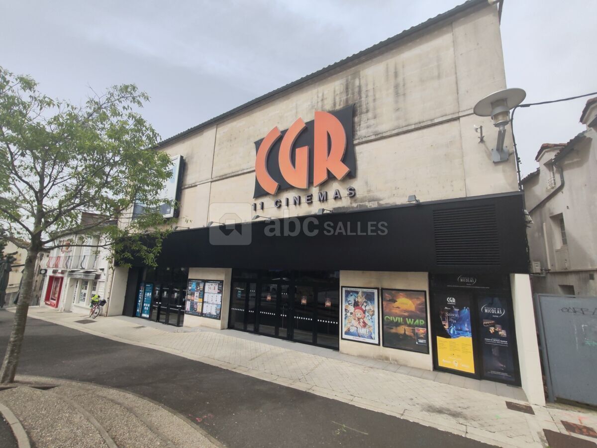 A cinema with a black facade and the letters "CGR" prominently displayed.
