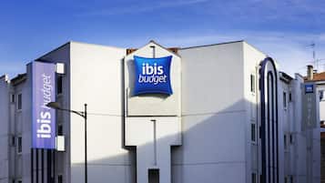 A building with a sign reading "ibis budget" and another sign indicating "ibis budget hotel".