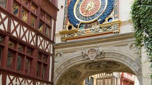 A historic building with a decorative clock and a half-timbered facade. - ibis budget Rouen Sud Zenith (Saint-Etienne-du-Rouvray)