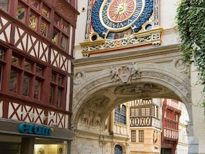 A historic building with a decorative clock and a half-timbered facade. - ibis budget Rouen Sud Zenith (Saint-Etienne-du-Rouvray)