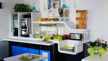 A modern breakfast bar with a coffee machine, toaster, and various food items.