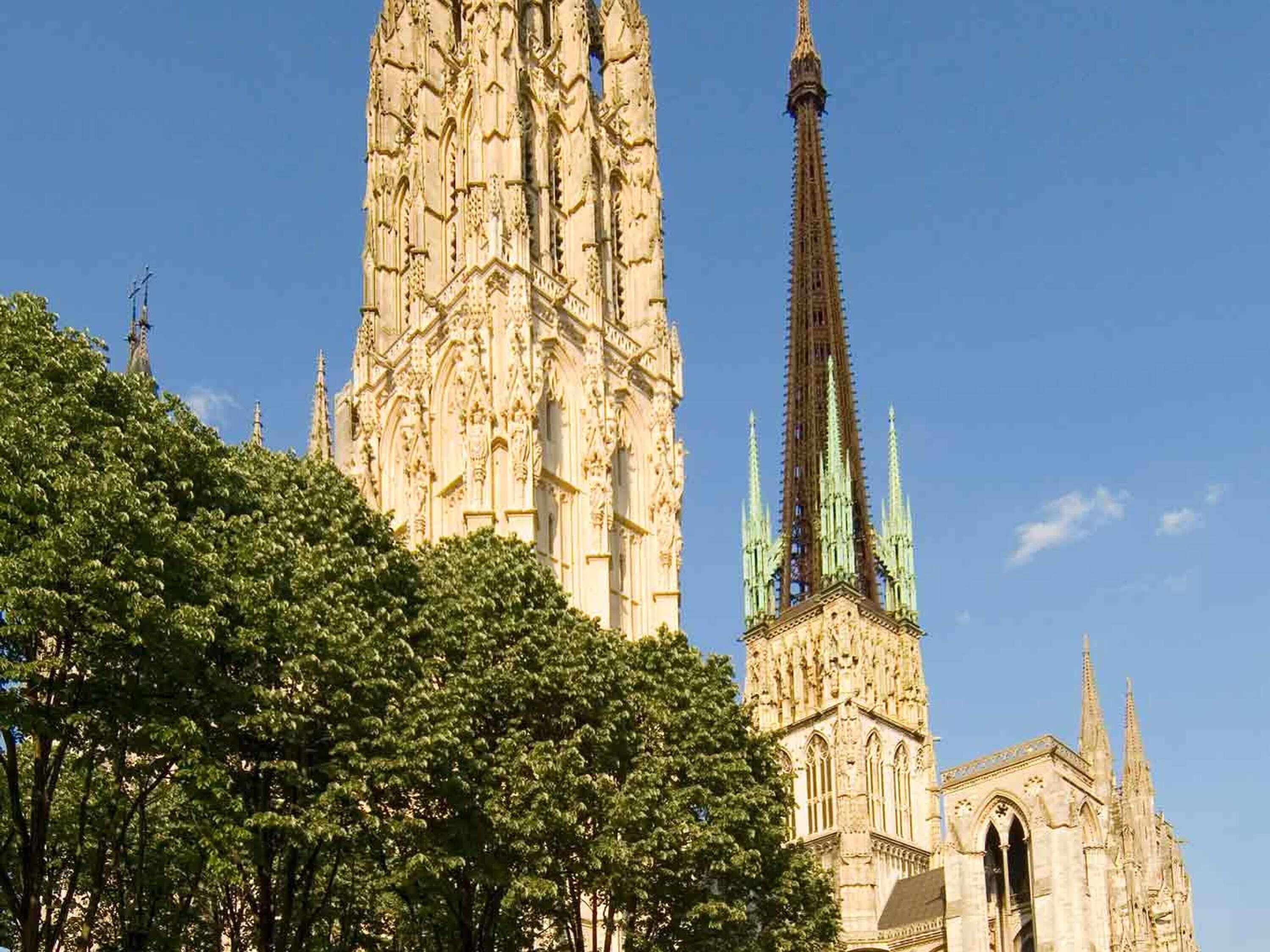 A cathedral with a tall spire and intricate stonework.
