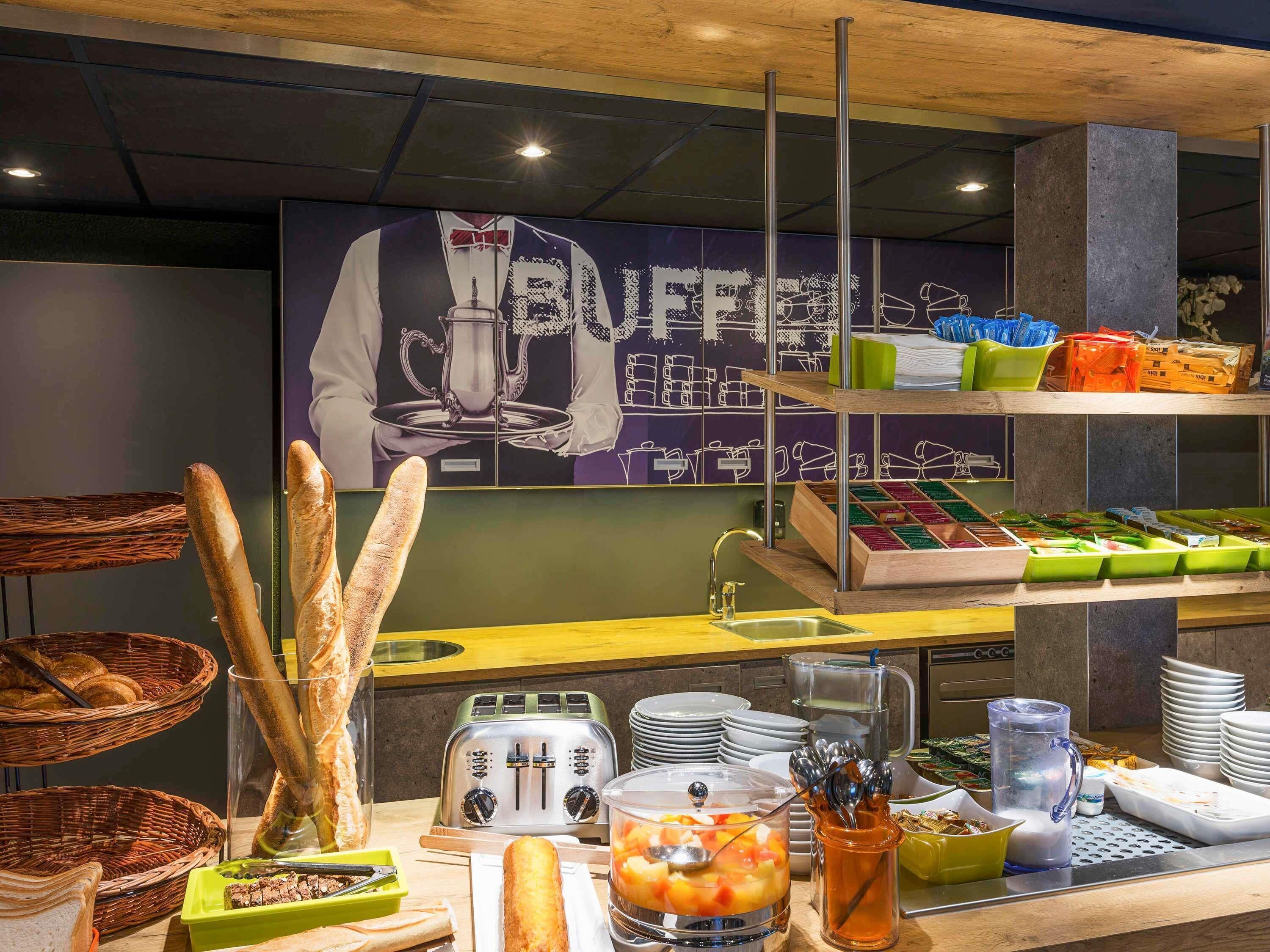 A buffet setup with bread, a toaster, and various food containers.