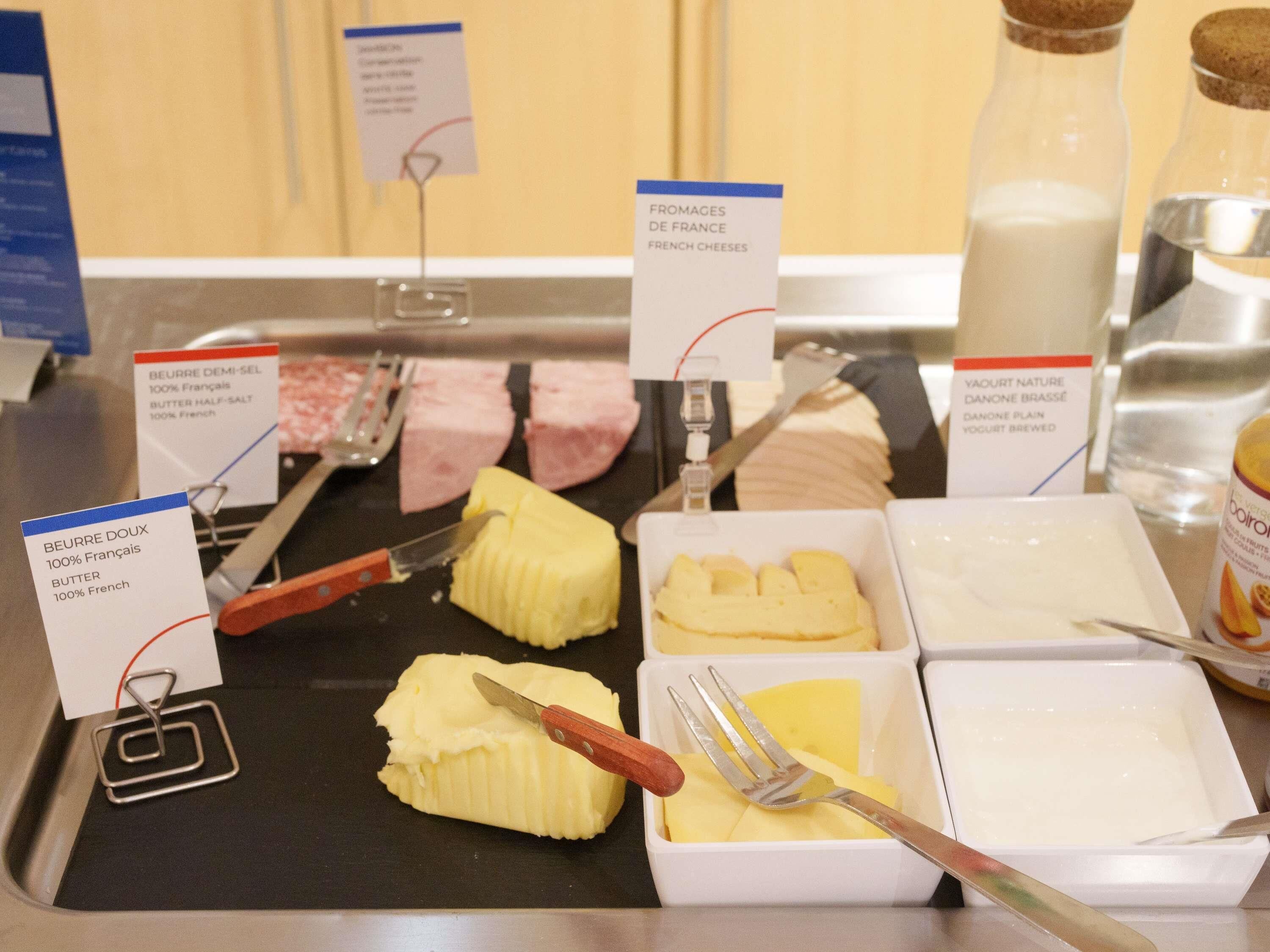 A breakfast buffet with various food items and utensils.