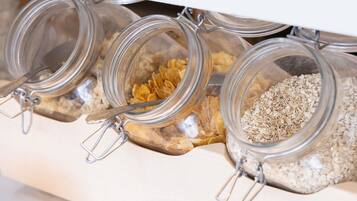 Three glass jars with metal clasps, containing different food items, placed on a shelf.