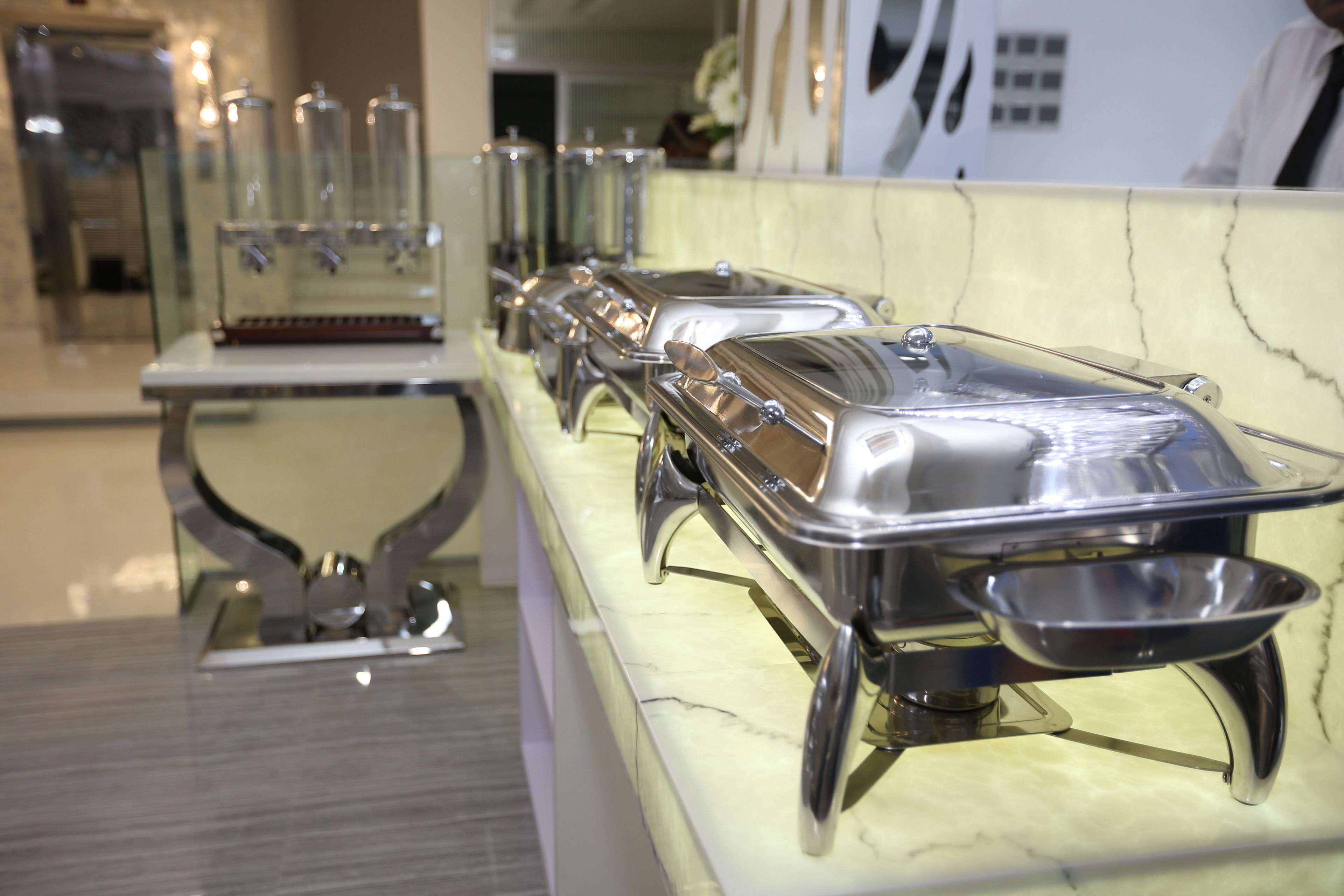 A buffet setup with multiple serving stations and a marble countertop.