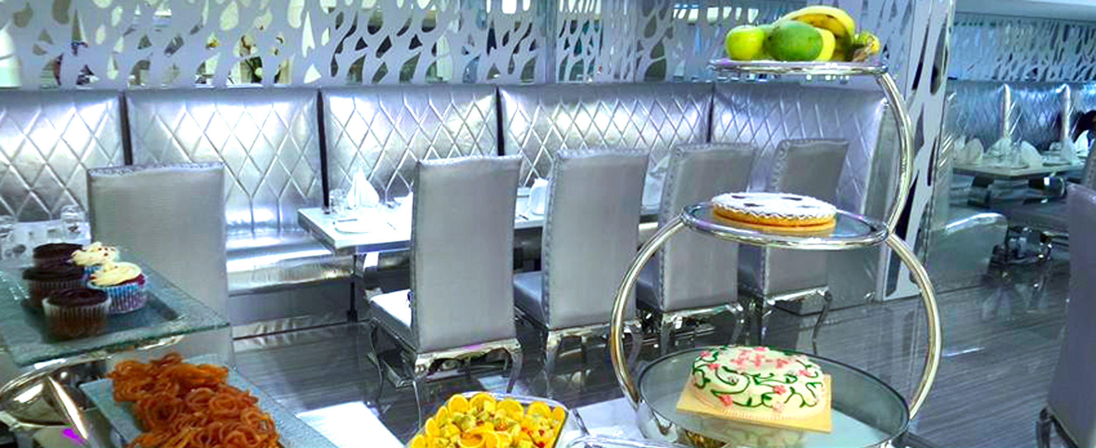 A buffet with various desserts and fruits.
