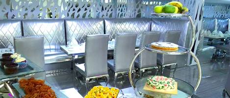 A buffet with various desserts and fruits.