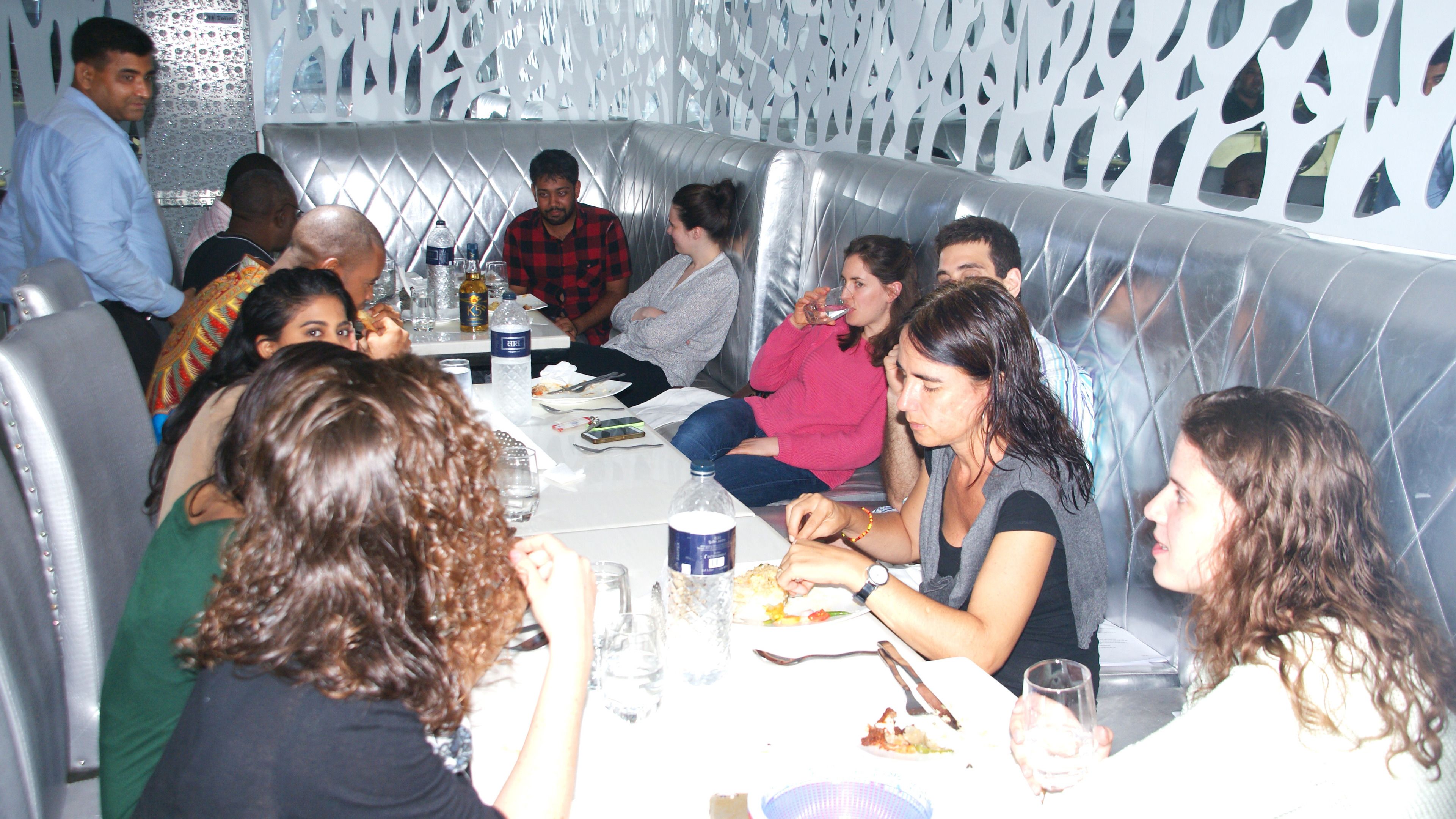 A group of people dining in a restaurant with a modern, geometric interior design.