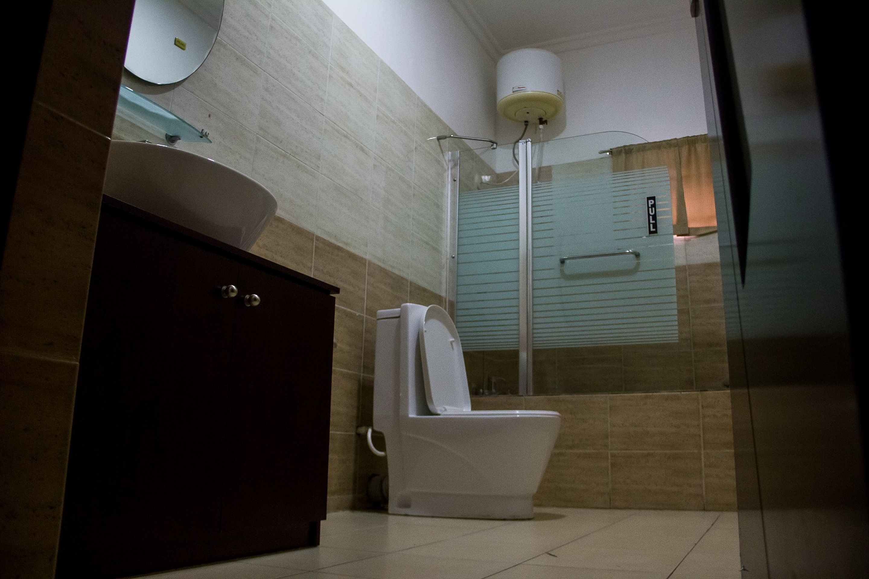 A bathroom with a toilet, a sink, and a shower.