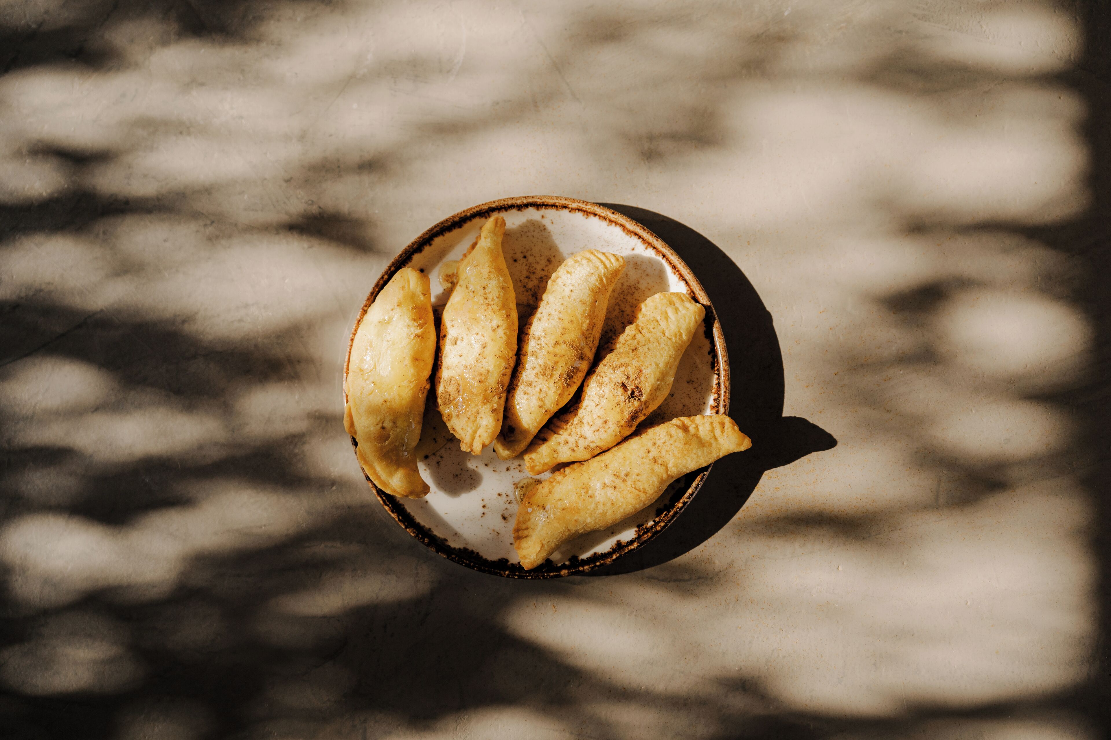 A bowl of pastries on a plate.