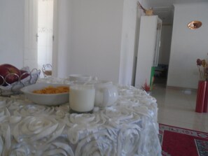 A dining table with a white tablecloth, bowls of food, and a milk jug. - Bel Rea Guest House (Nata)