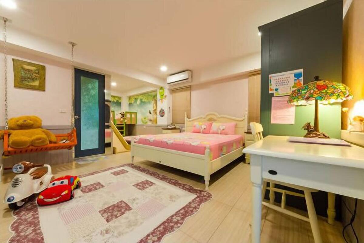 A child's bedroom with a bed, a desk, a chair, a teddy bear, and a toy car.