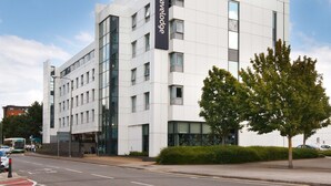 A modern building with a sign for 'Travelodge'. It features a clean, white facade with large windows and a flat roof. - Travelodge Cardiff Atlantic Wharf Hotel (Cardiff)