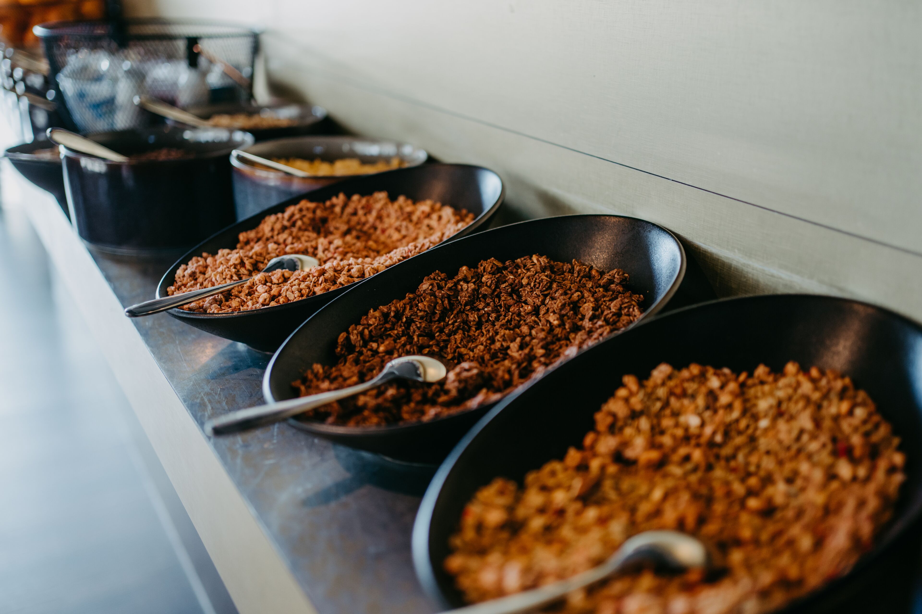 A buffet line with multiple serving dishes containing food.