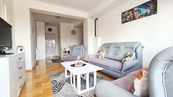 Deluxe Apartment | Living area | LCD TV, tablet