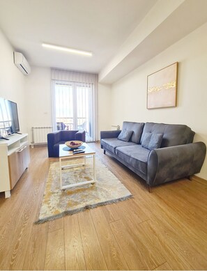 Deluxe Apartment | Living area | LCD TV, tablet