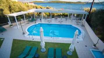 Outdoor pool, open 10:00 AM to 10:00 PM, pool umbrellas, pool loungers