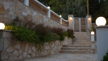 A stone staircase with wooden railings and a stone wall.
